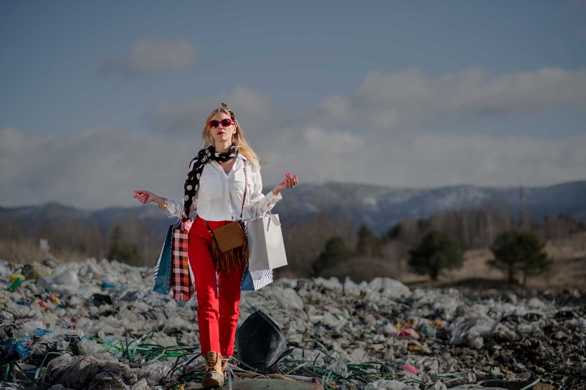 Woman with clothing in landfill.