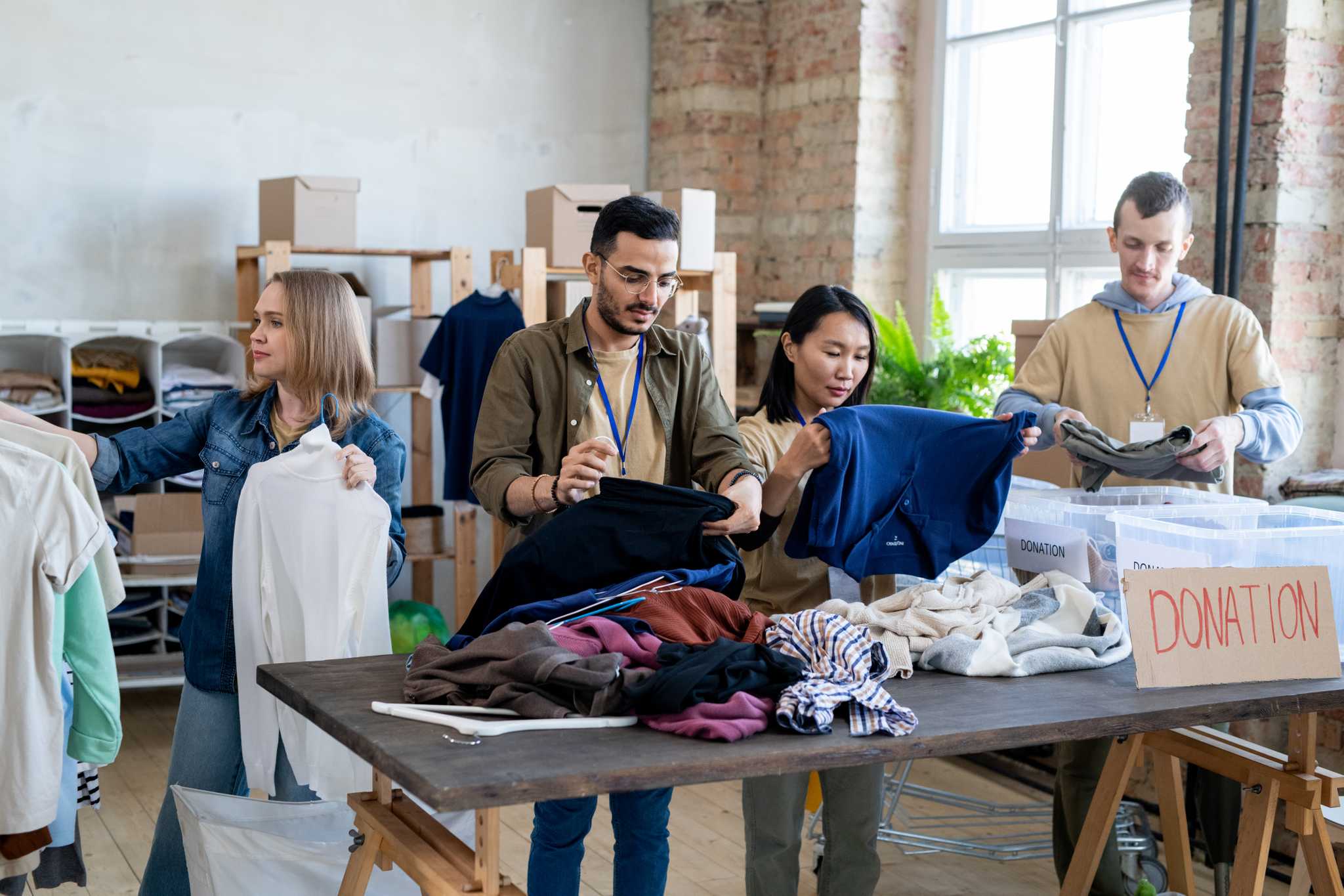 Volunteers sorting through clothing donations.